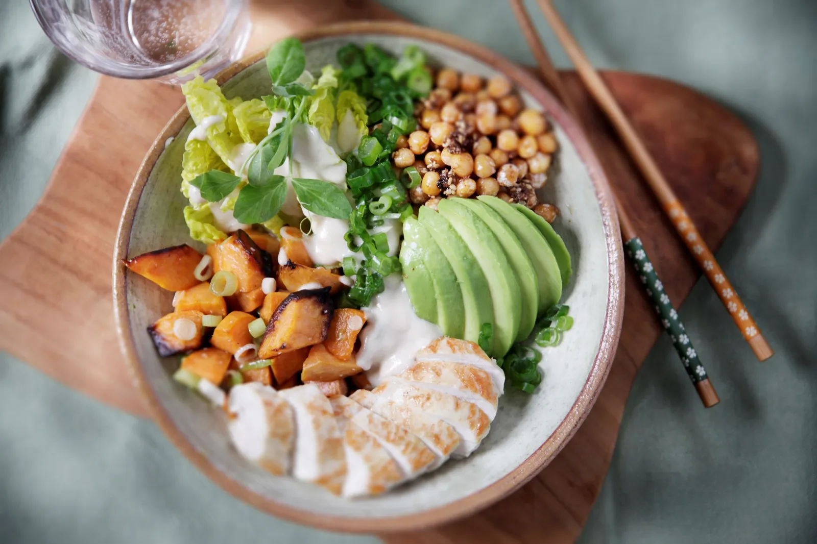 Buddha bowl med stegt kylling, ristede kikærter og avocado i tahindressing